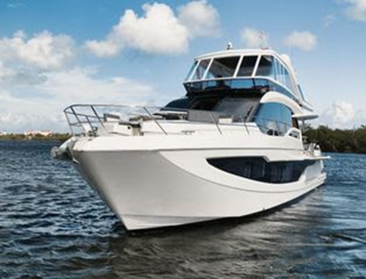 a white boat on the water aboard JUST IN TIME Yacht for Sale