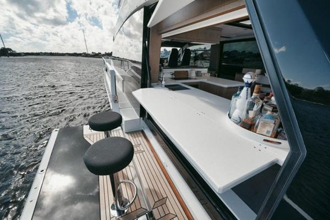 a boat with a table and chairs aboard JUST IN TIME Yacht for Sale