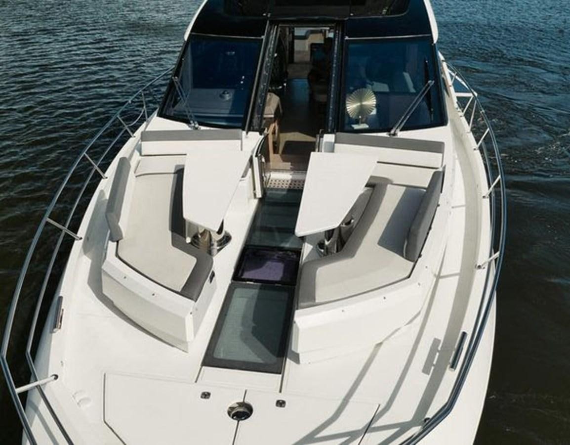 a white boat on the water aboard JUST IN TIME Yacht for Sale