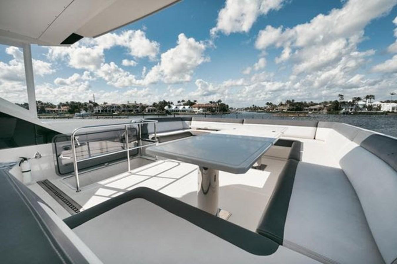 a deck with a view of a city and water aboard JUST IN TIME Yacht for Sale