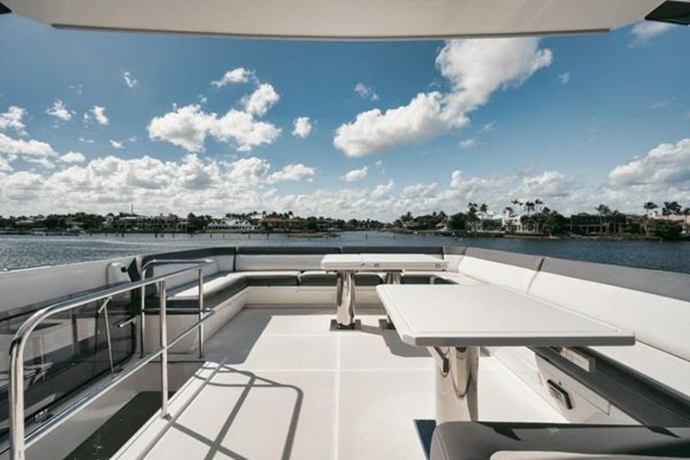 a white boat on a deck aboard JUST IN TIME Yacht for Sale