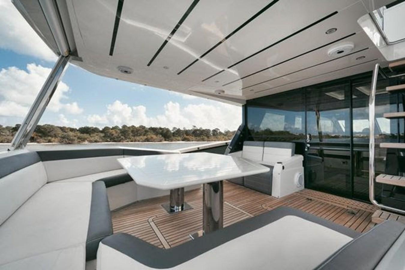 a room with a table and chairs aboard JUST IN TIME Yacht for Sale