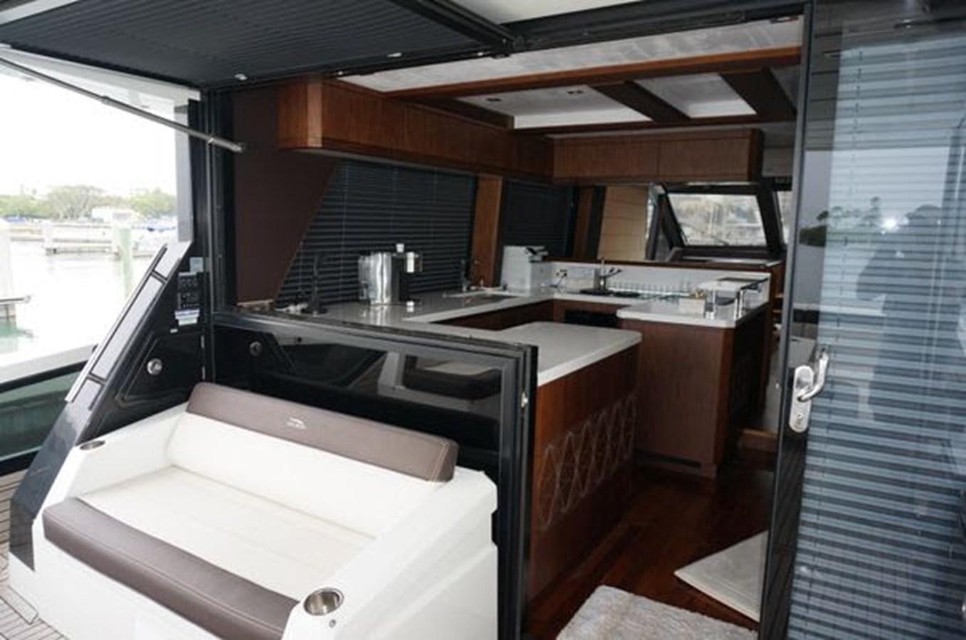 a kitchen with a large window aboard JUST IN TIME Yacht for Sale