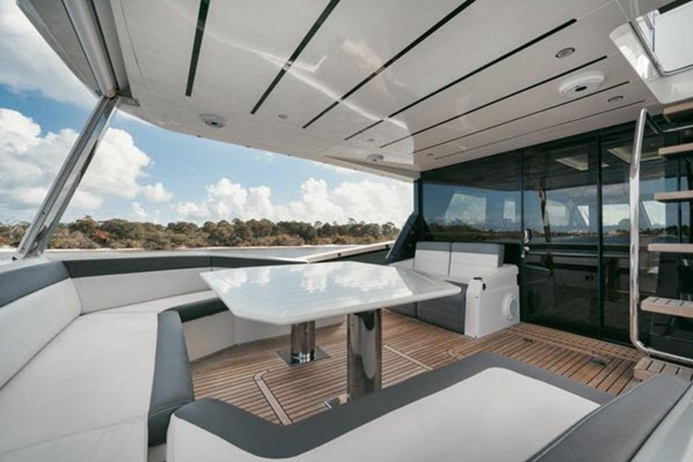 a large room with a table and chairs aboard JUST IN TIME Yacht for Sale