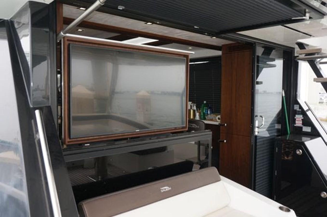 a large television in a room aboard JUST IN TIME Yacht for Sale