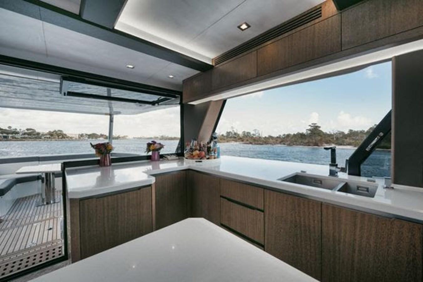 a kitchen with a large window aboard JUST IN TIME Yacht for Sale