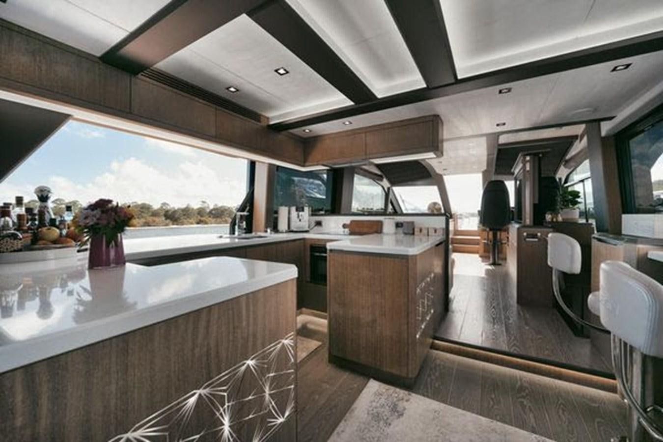 a kitchen with a large window aboard JUST IN TIME Yacht for Sale