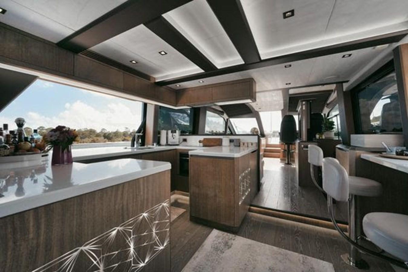 a large kitchen with a large window aboard JUST IN TIME Yacht for Sale
