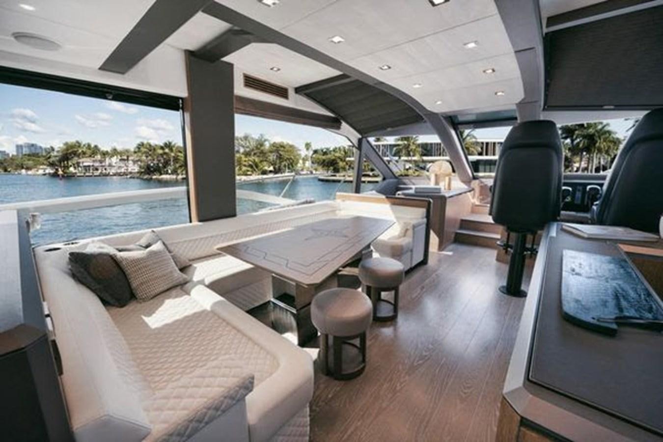 a room with a bed and a table and chairs aboard JUST IN TIME Yacht for Sale