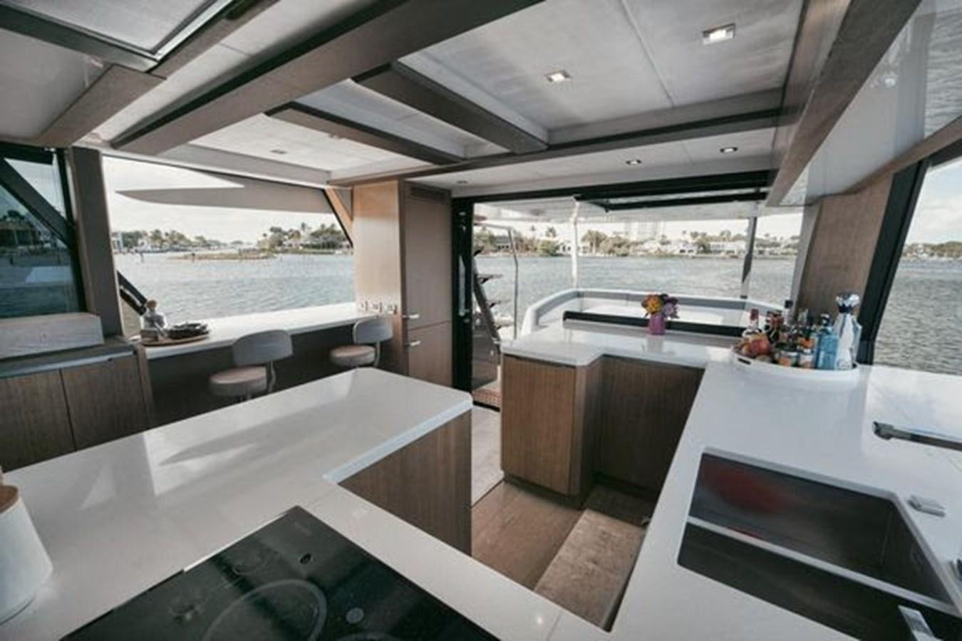a room with a table and chairs aboard JUST IN TIME Yacht for Sale