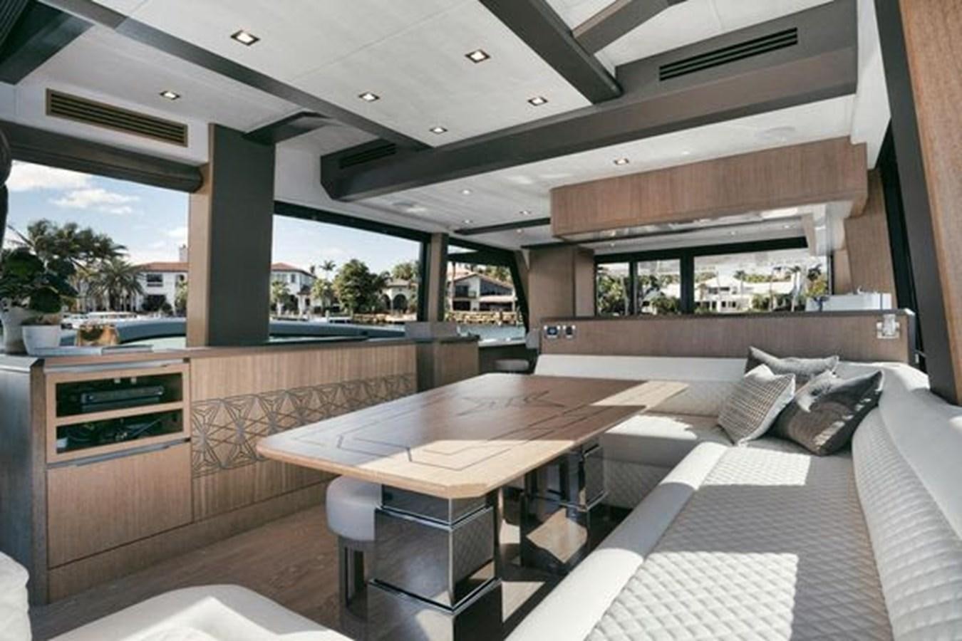 a room with a table and a bed aboard JUST IN TIME Yacht for Sale