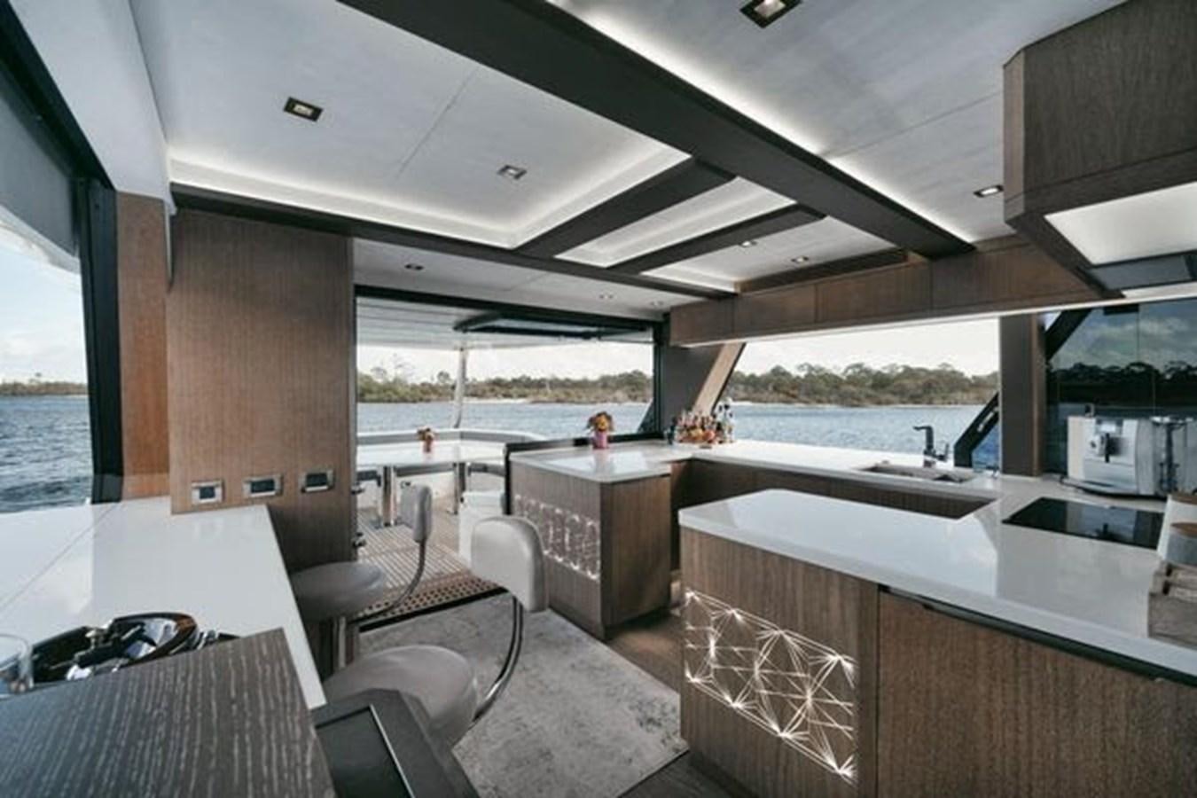a modern looking kitchen with a large window aboard JUST IN TIME Yacht for Sale