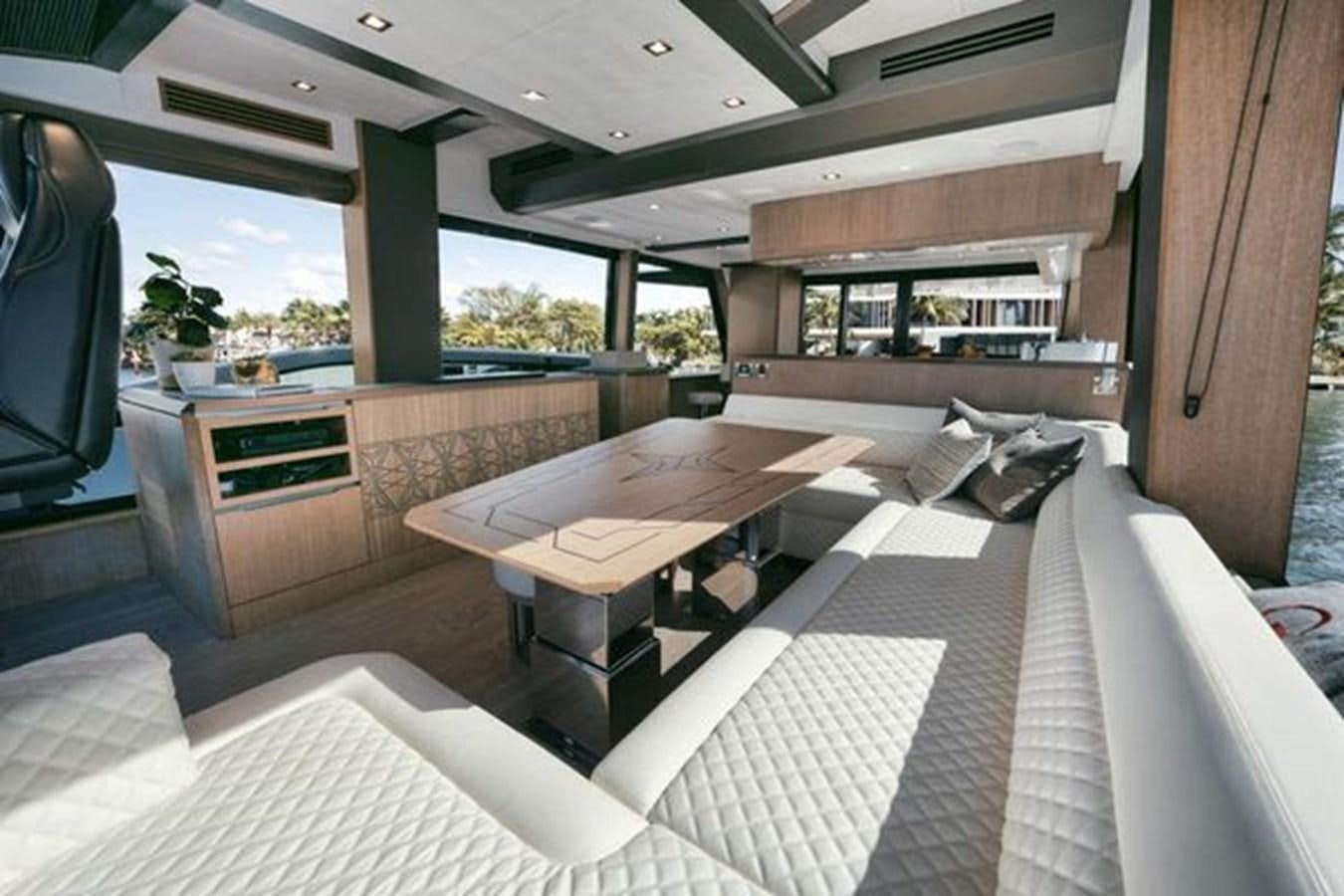 a room with a table and chairs aboard JUST IN TIME Yacht for Sale
