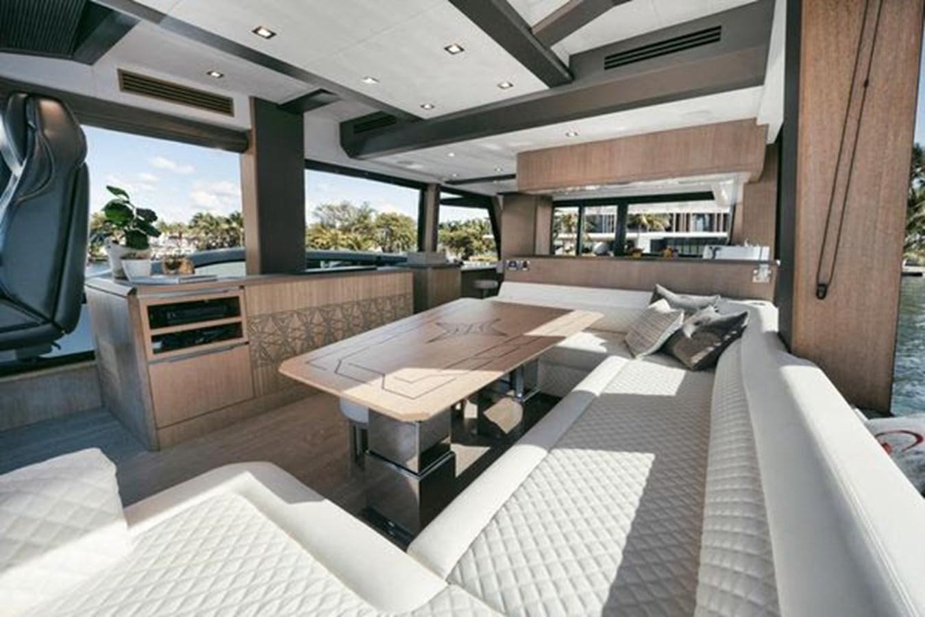 a room with a table and chairs aboard JUST IN TIME Yacht for Sale