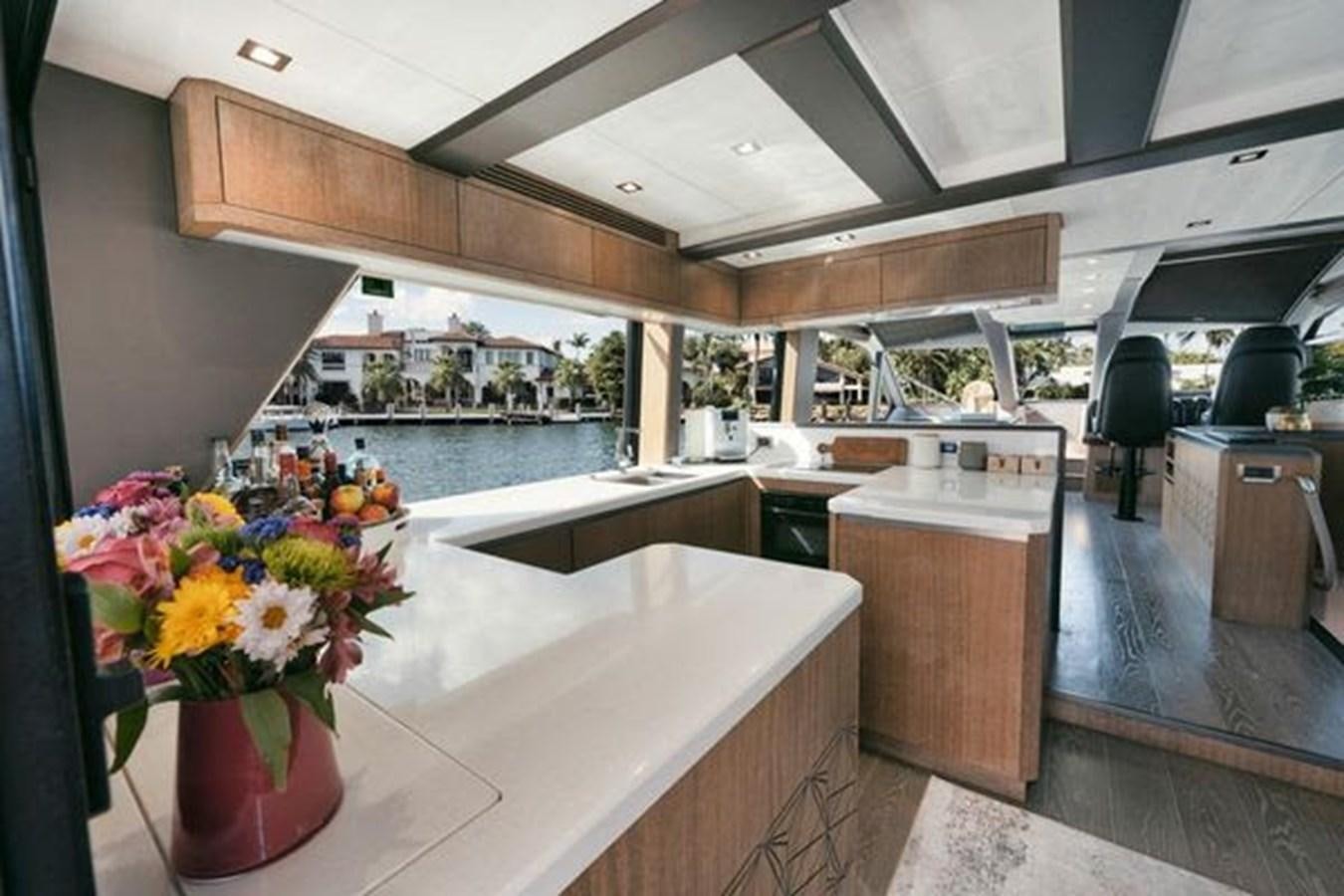 a kitchen with a large island aboard JUST IN TIME Yacht for Sale
