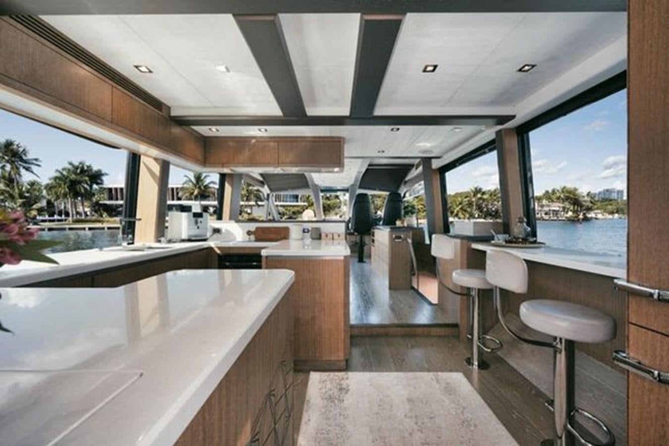 a kitchen with a large window aboard JUST IN TIME Yacht for Sale