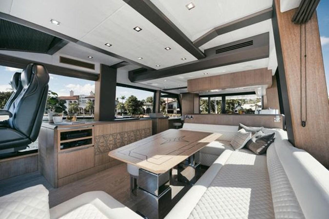 a room with a table and chairs aboard JUST IN TIME Yacht for Sale