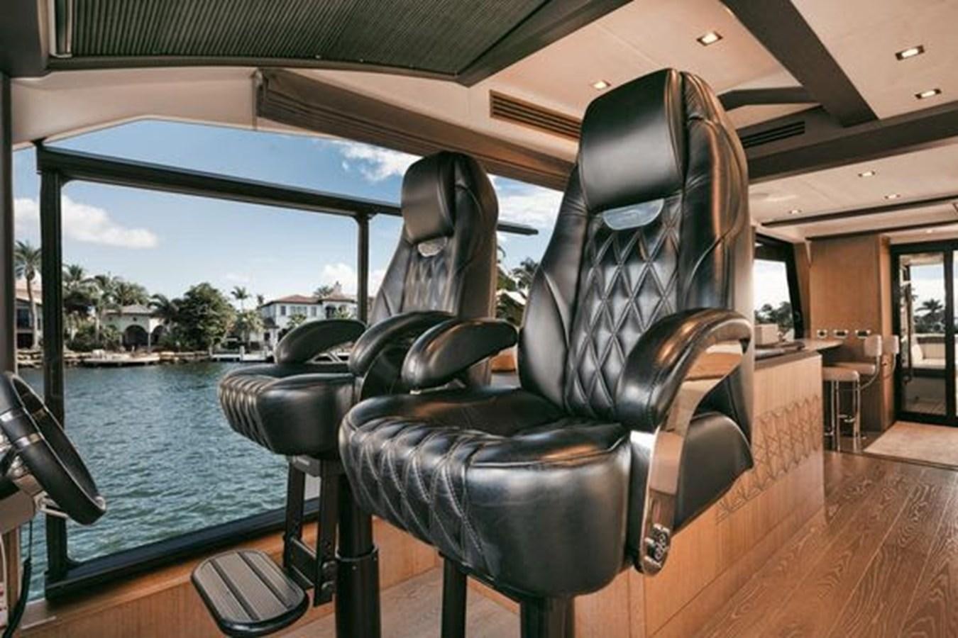 a couple of chairs by a pool aboard JUST IN TIME Yacht for Sale