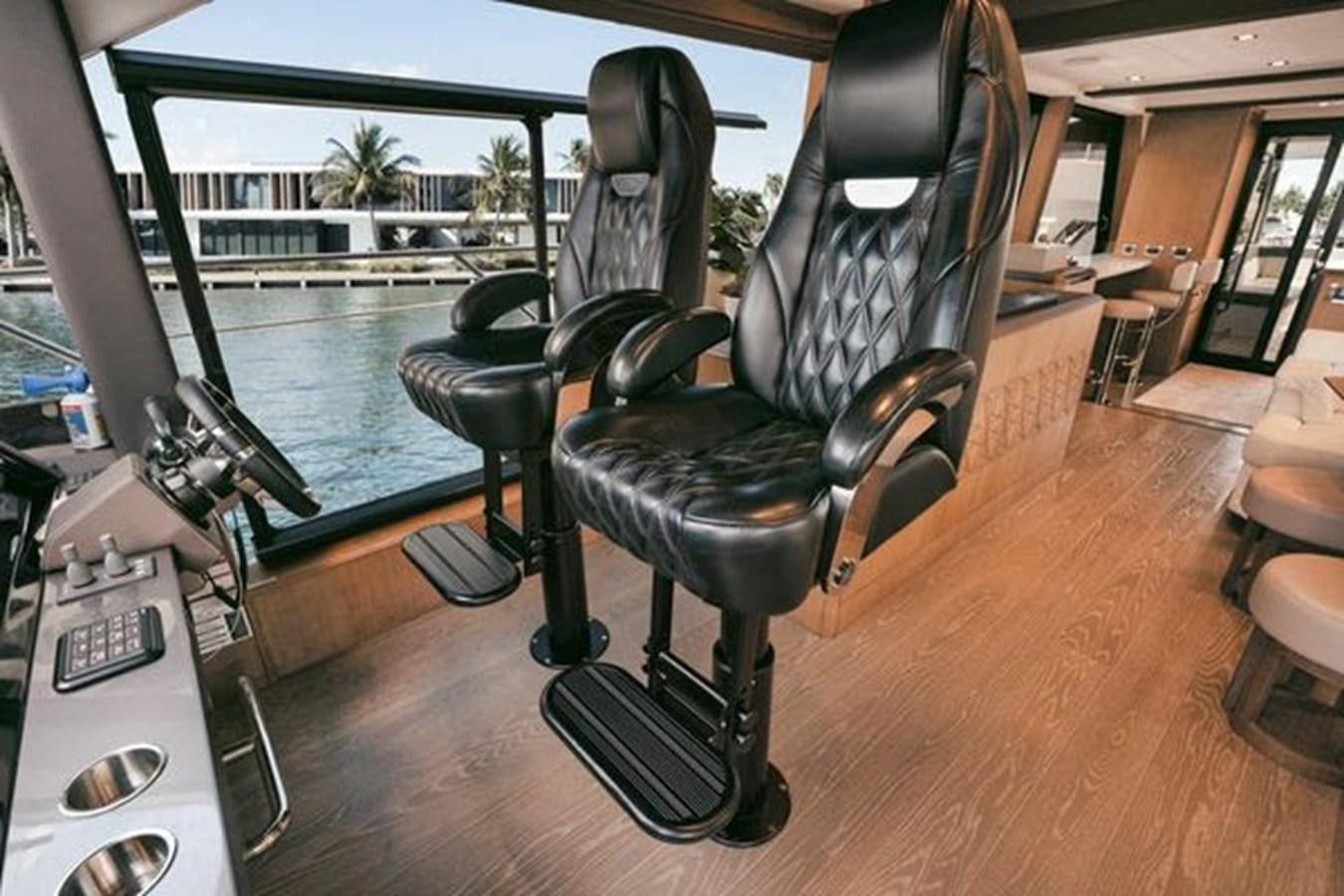 a black office chair next to a pool aboard JUST IN TIME Yacht for Sale