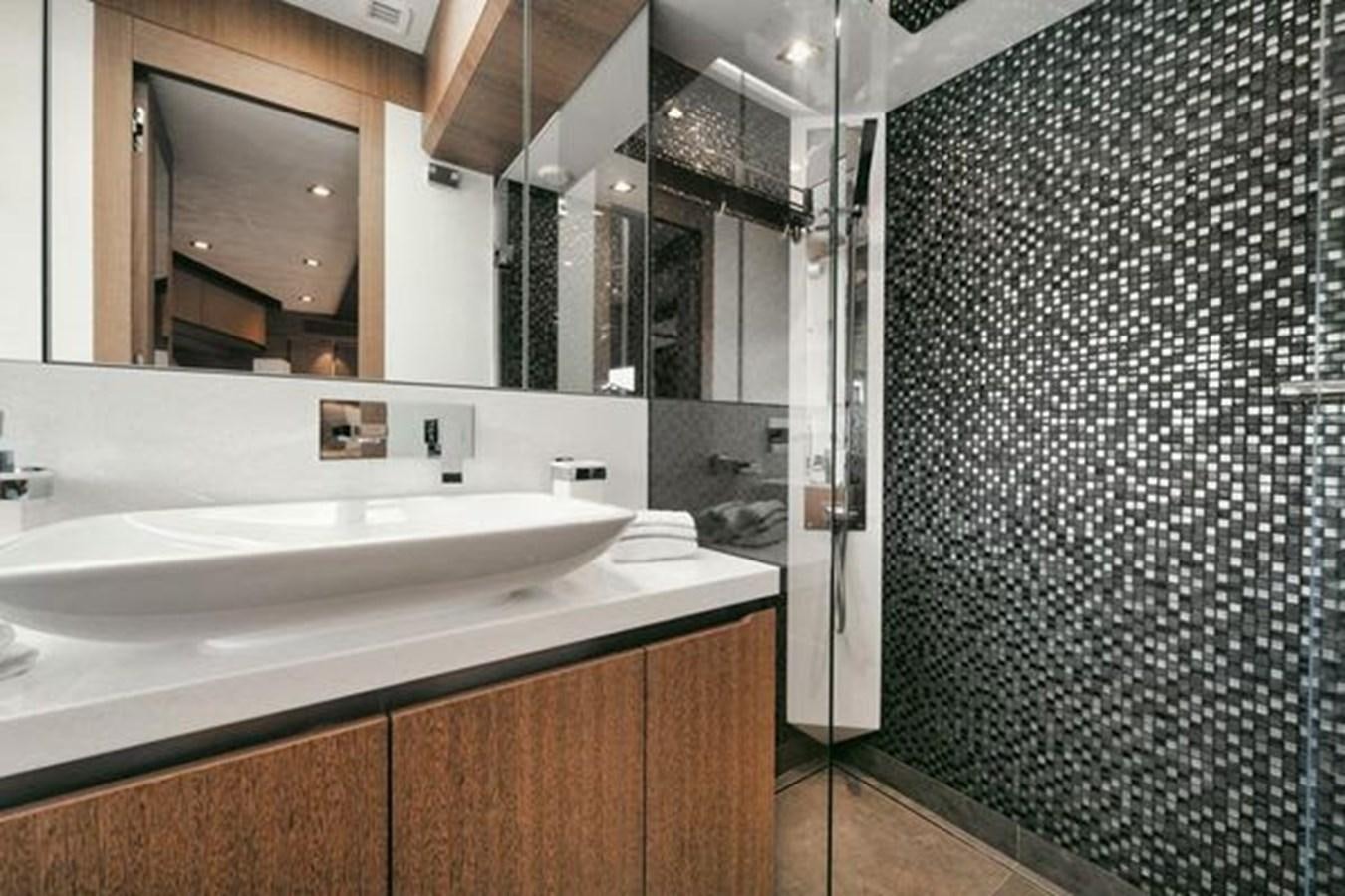 a bathroom with a sink and shower aboard JUST IN TIME Yacht for Sale