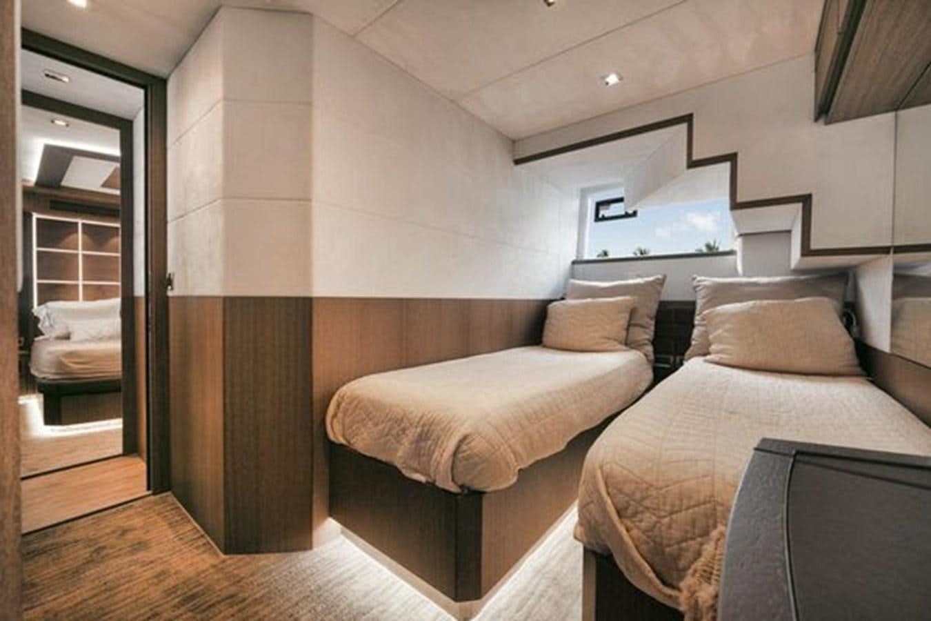 a bedroom with a bed and a tv aboard JUST IN TIME Yacht for Sale