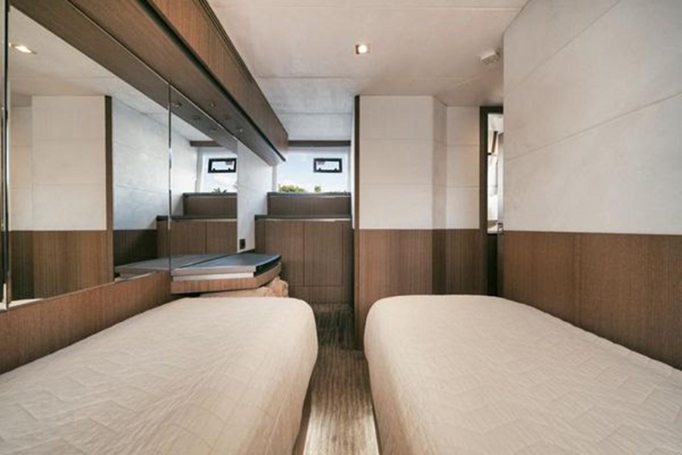 a room with a bed and a desk aboard JUST IN TIME Yacht for Sale