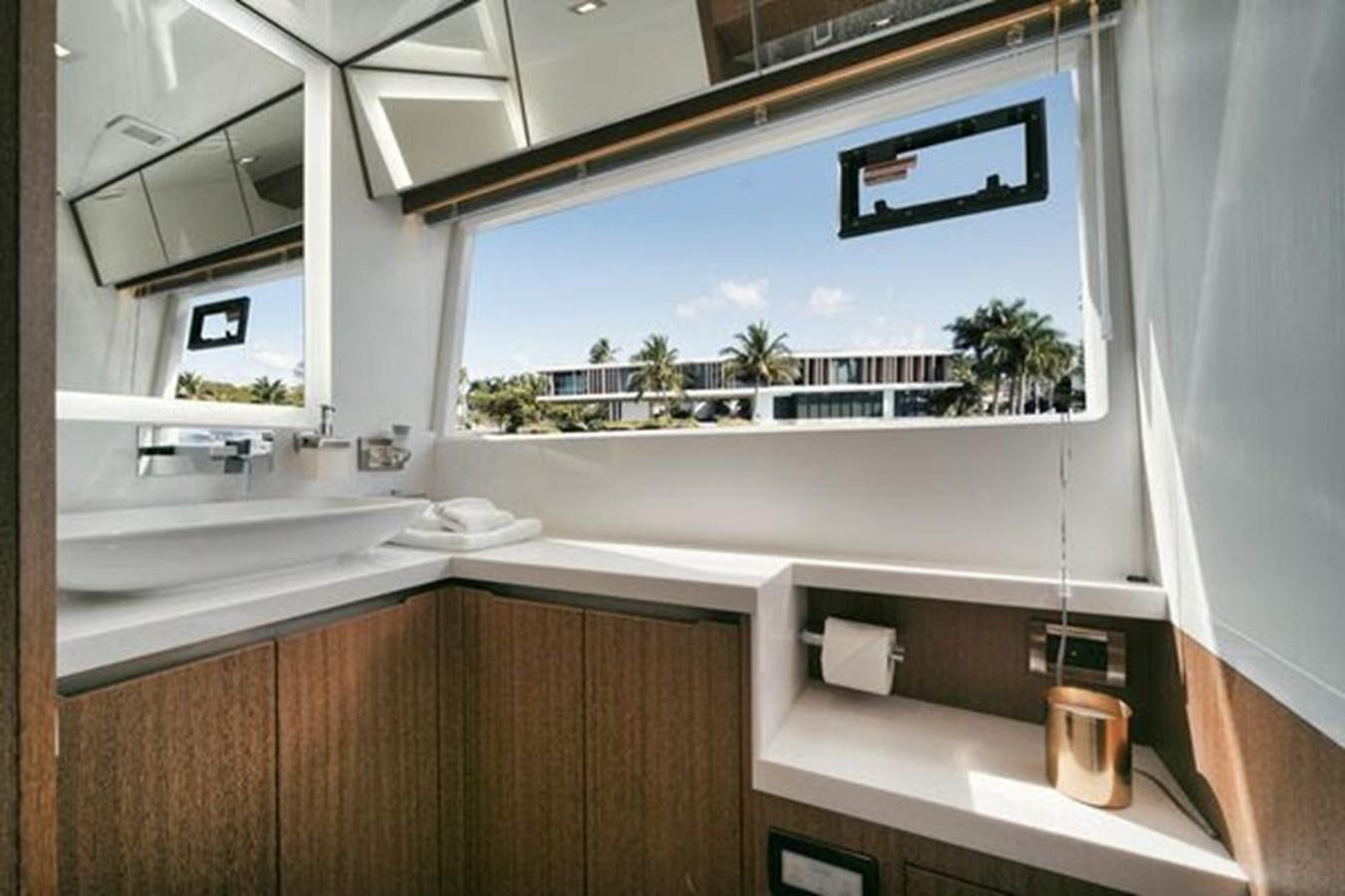 a bathroom with a large window aboard JUST IN TIME Yacht for Sale