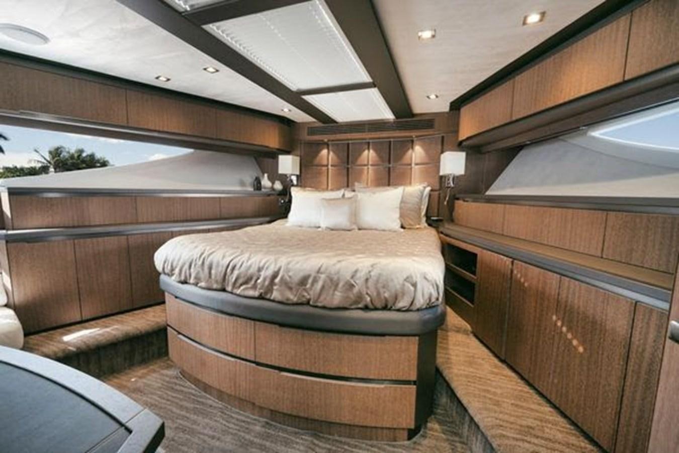 a room with a bed and a wood cabinet aboard JUST IN TIME Yacht for Sale
