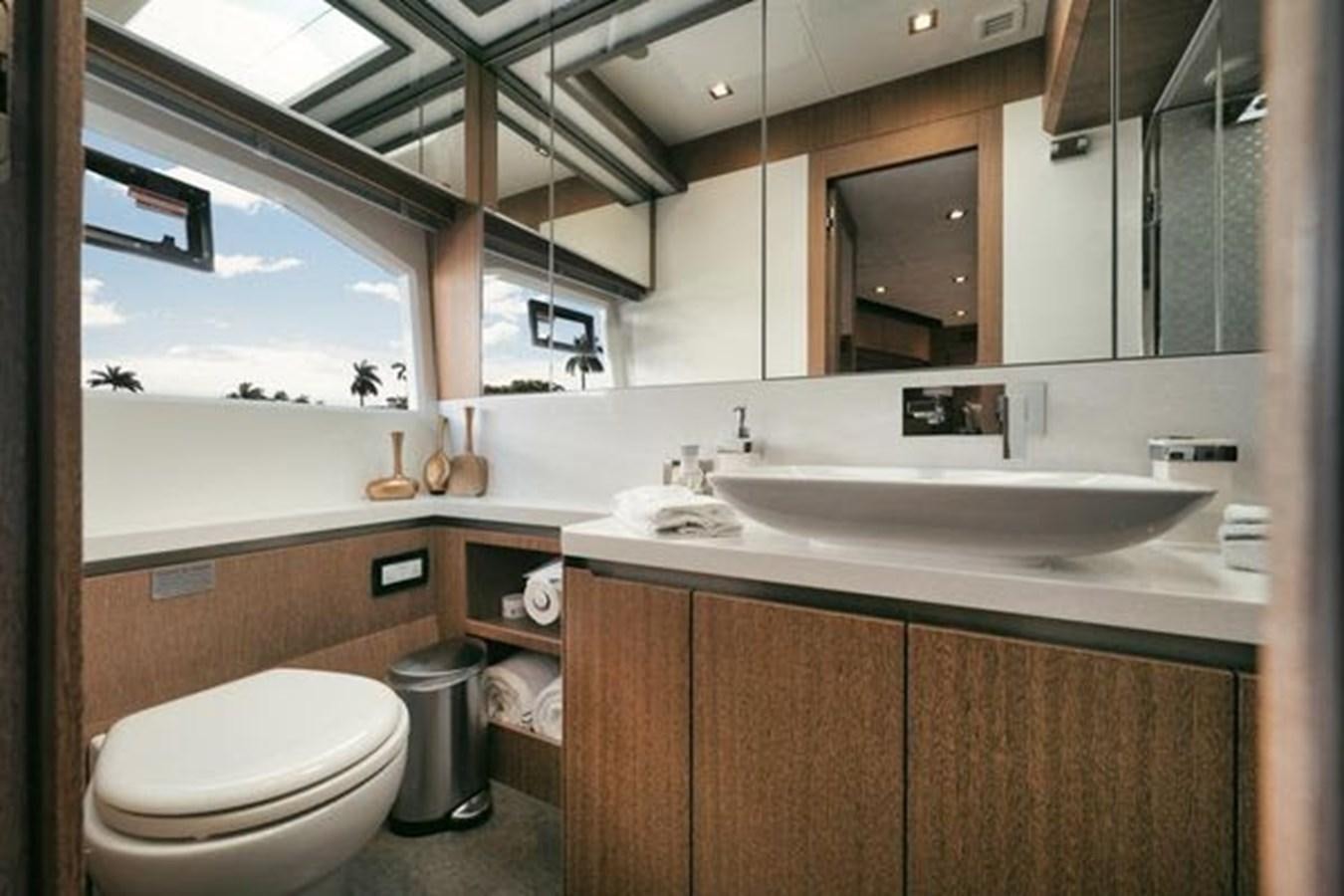 a bathroom with a sink toilet and a mirror aboard JUST IN TIME Yacht for Sale
