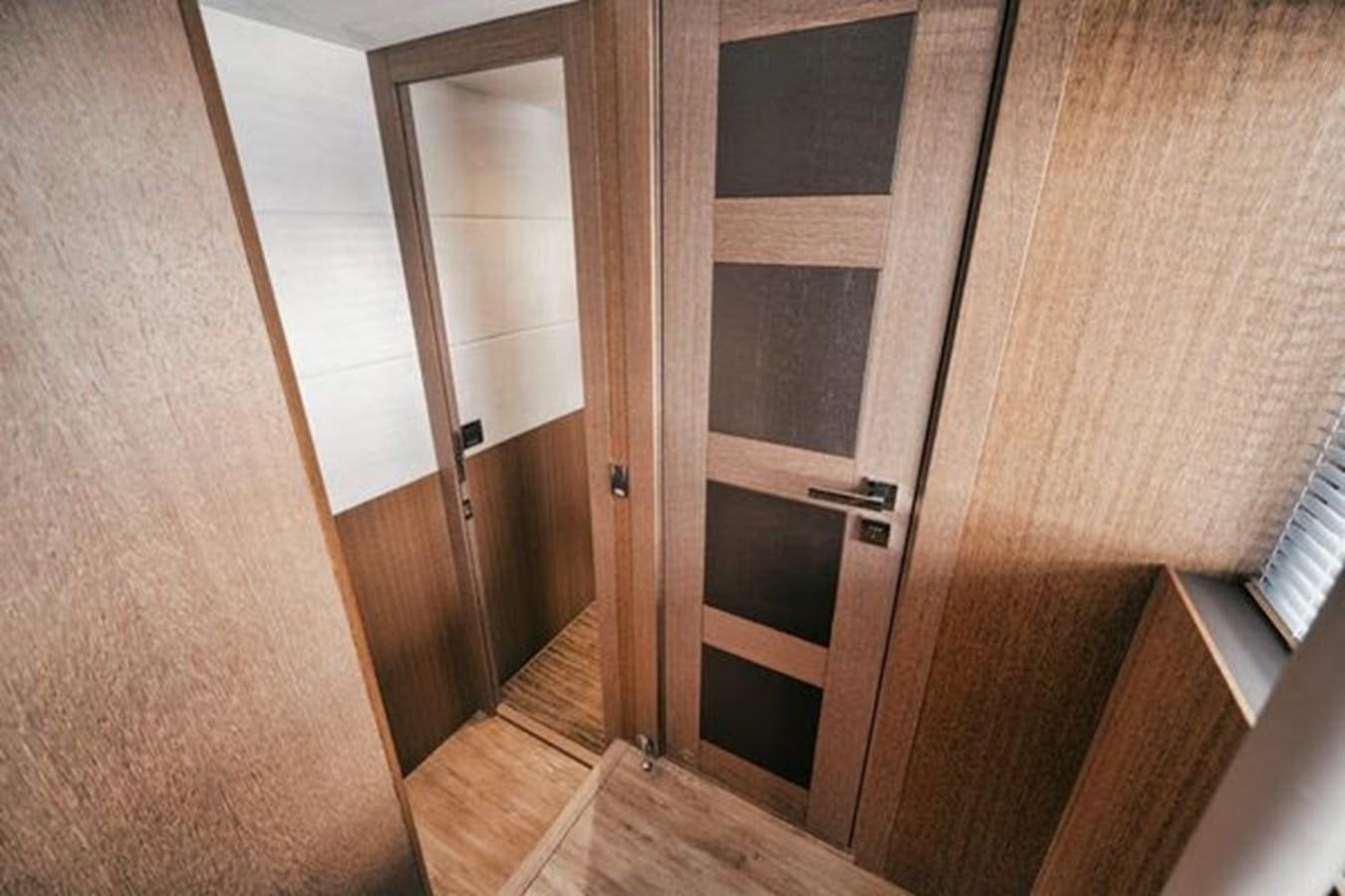 a closet with wooden doors aboard JUST IN TIME Yacht for Sale