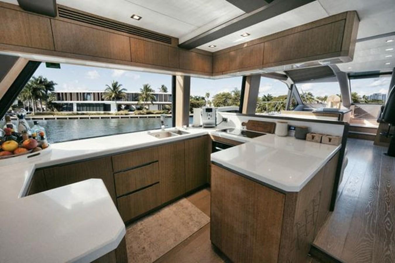 a kitchen with a large island aboard JUST IN TIME Yacht for Sale