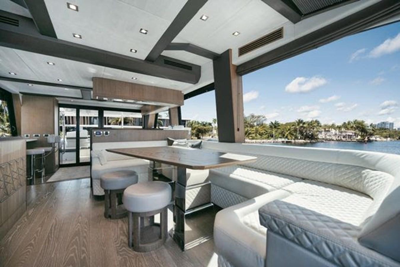 a large room with a table and chairs aboard JUST IN TIME Yacht for Sale
