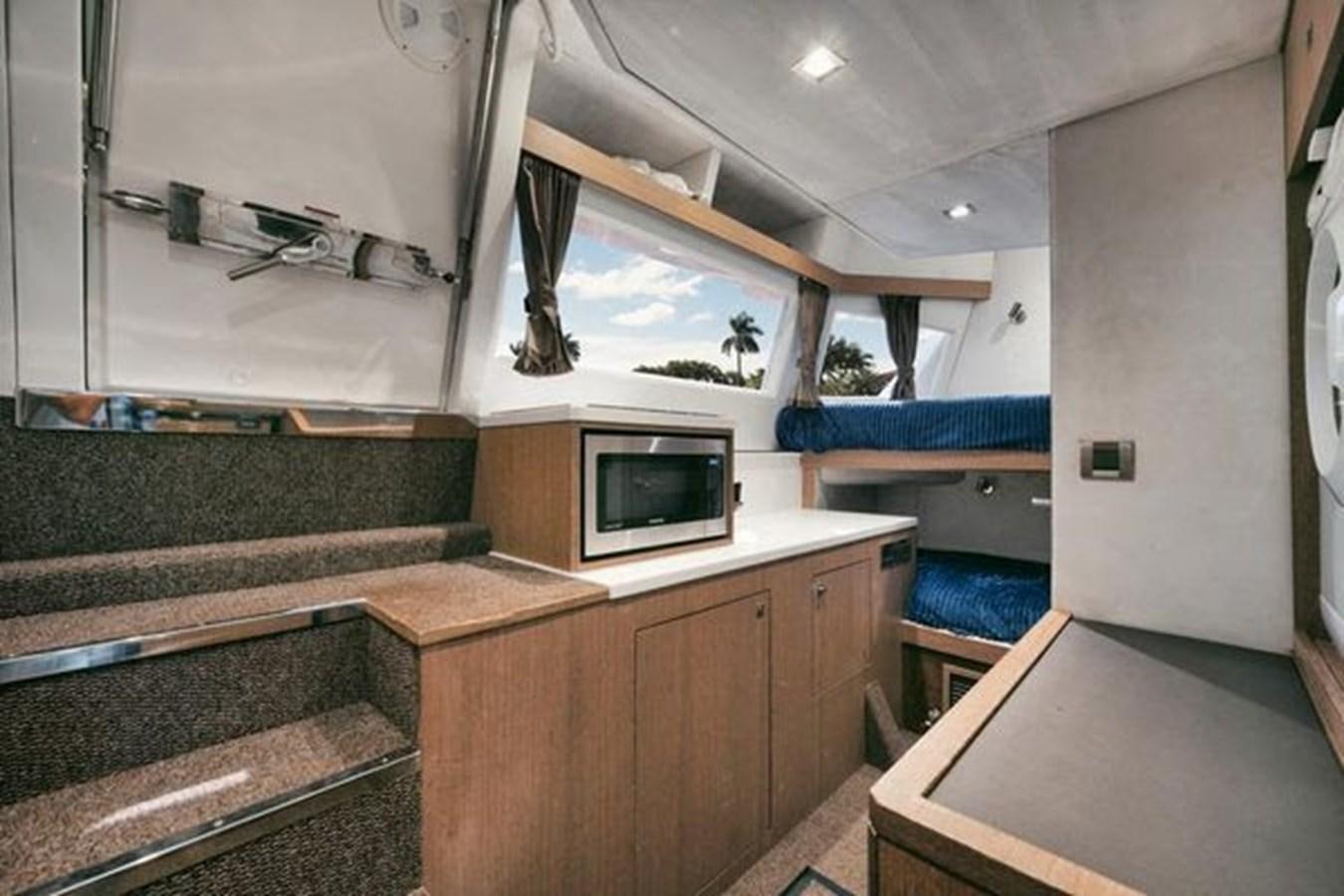 a room with a microwave oven and a sink aboard JUST IN TIME Yacht for Sale
