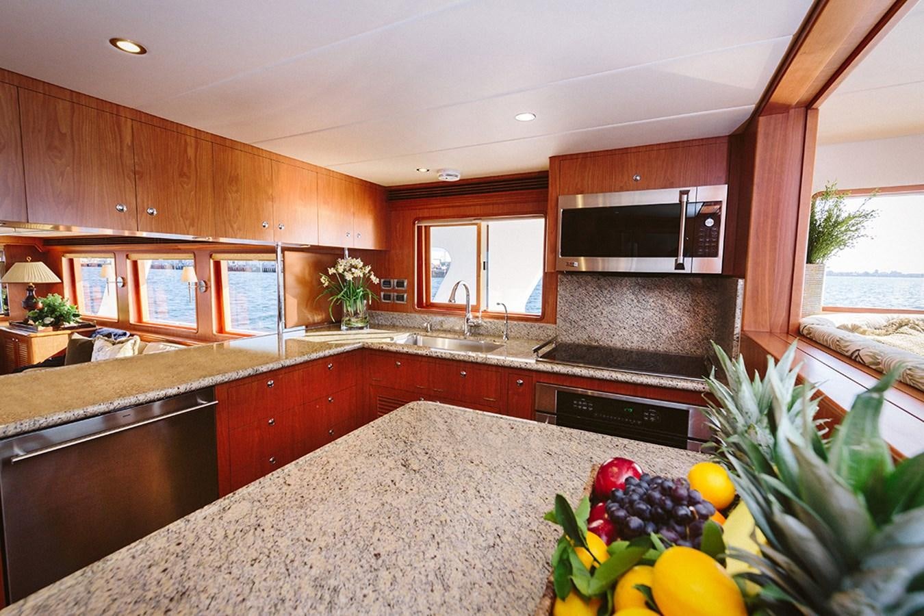 a kitchen with wooden cabinets aboard 44 NORTH Yacht for Sale
