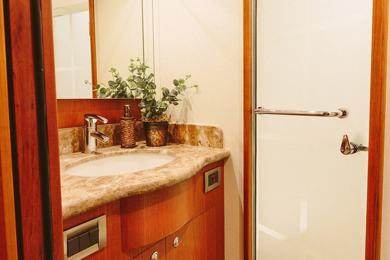 a bathroom with a sink and a mirror aboard 44 NORTH Yacht for Sale