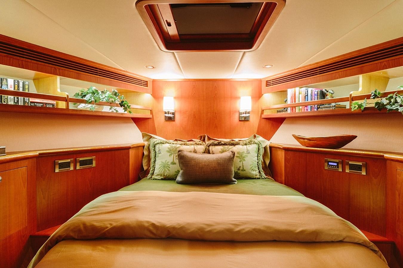 a bed with a wooden headboard aboard 44 NORTH Yacht for Sale