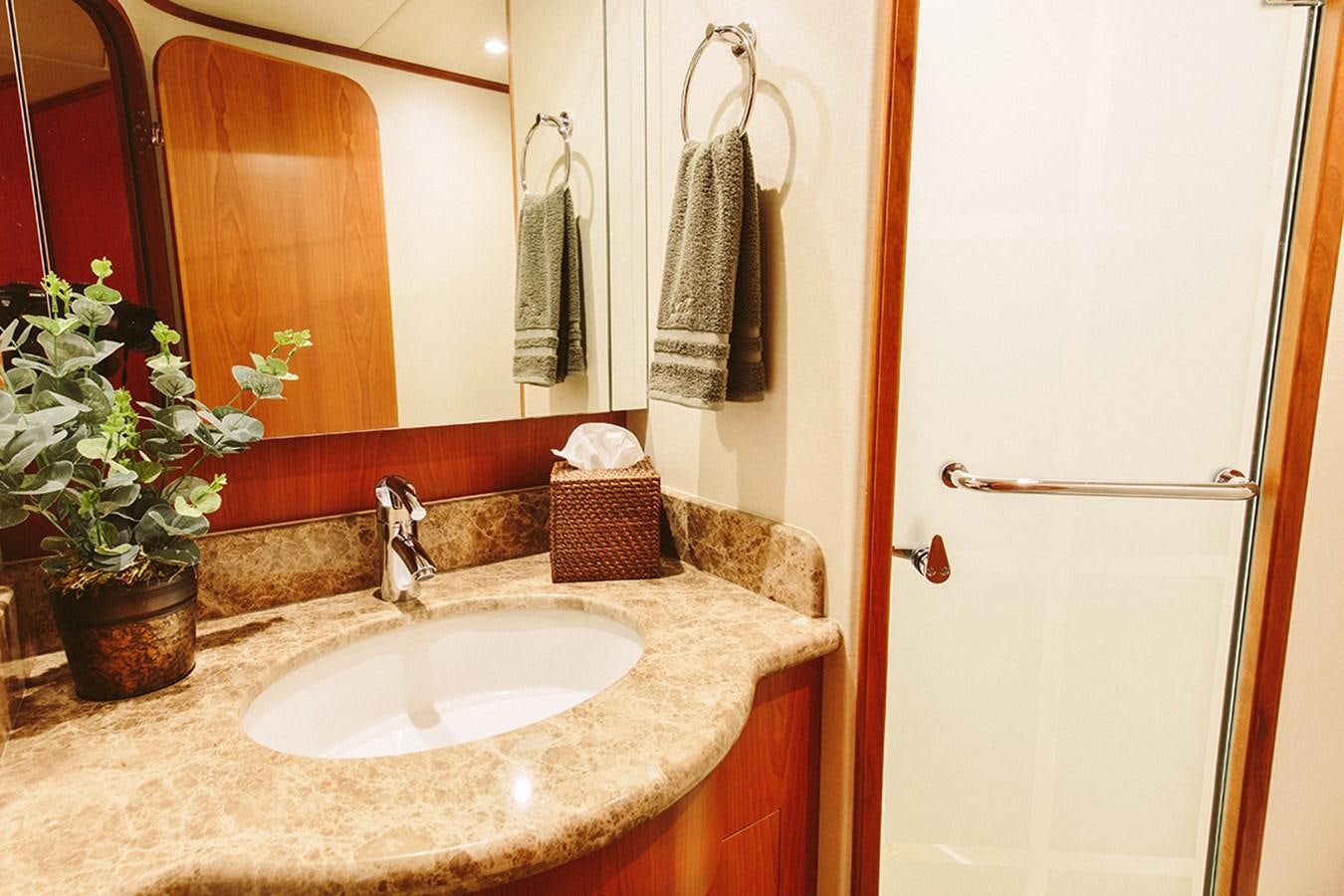 a bathroom with a sink and mirror aboard 44 NORTH Yacht for Sale