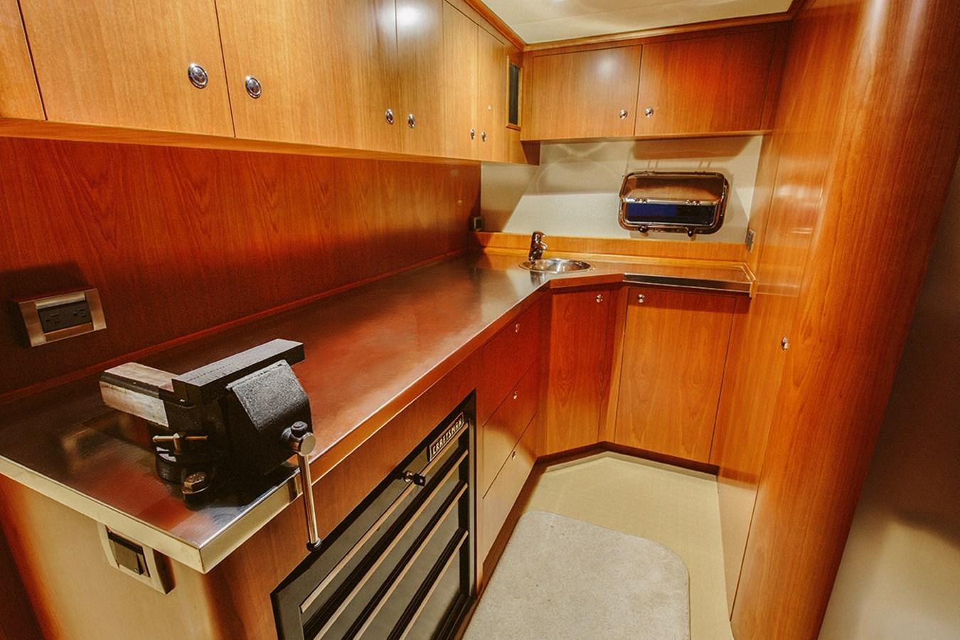 a kitchen with wooden cabinets aboard 44 NORTH Yacht for Sale