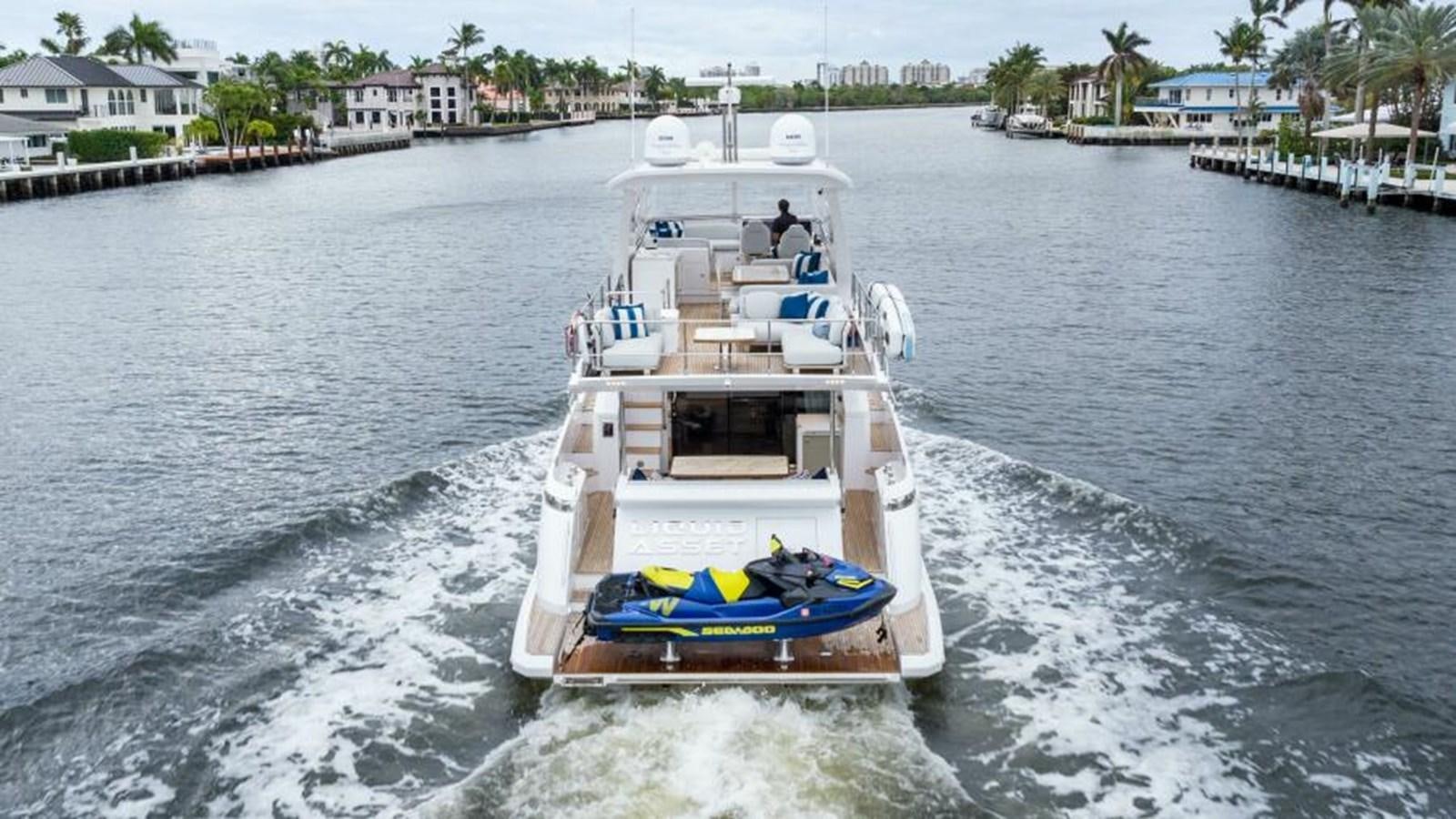 a boat sailing on the water aboard LIQUID ASSET Yacht for Sale
