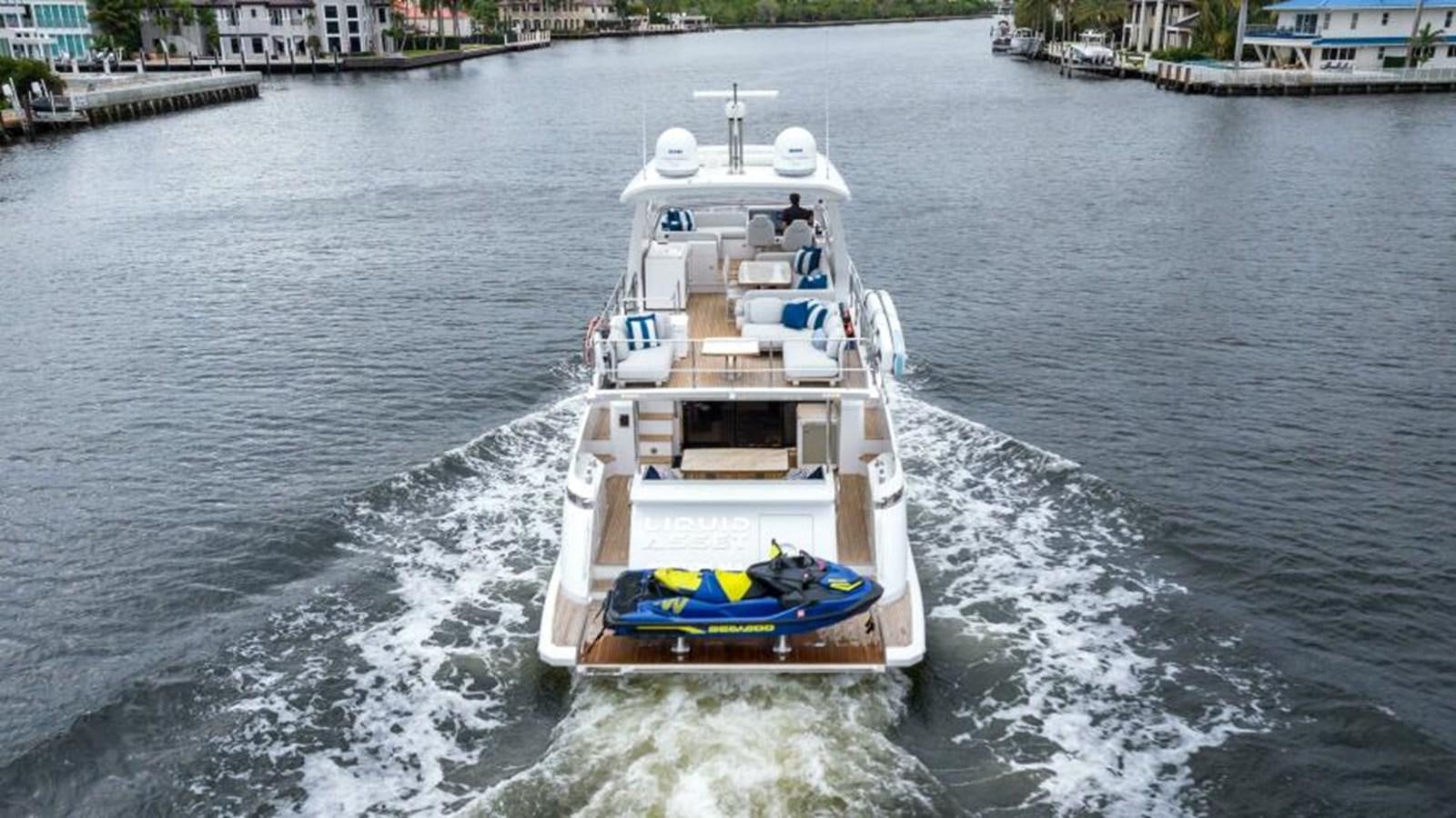 a boat sailing on the water aboard LIQUID ASSET Yacht for Sale