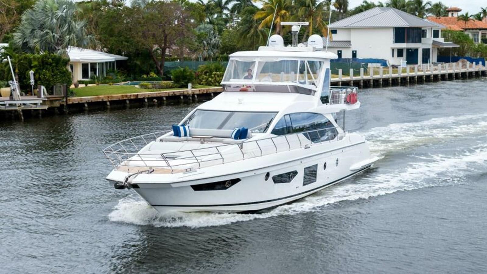 a white boat on the water aboard LIQUID ASSET Yacht for Sale