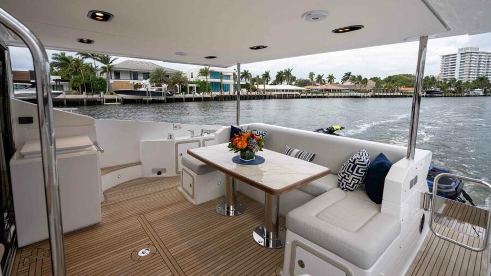 a room with a table and chairs aboard LIQUID ASSET Yacht for Sale
