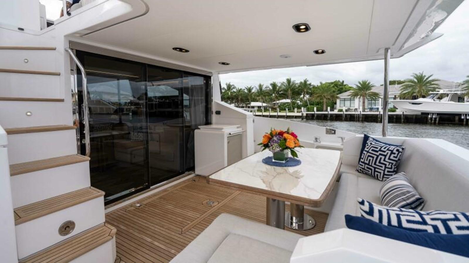 a room with a table and chairs aboard LIQUID ASSET Yacht for Sale