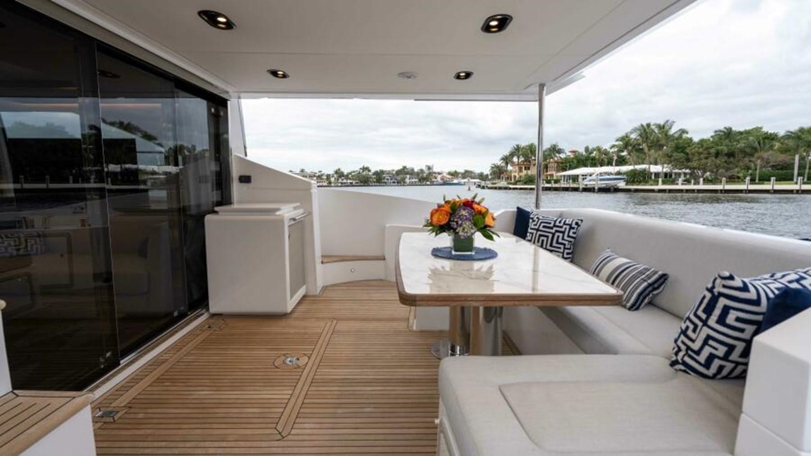 a boat with a table and chairs aboard LIQUID ASSET Yacht for Sale
