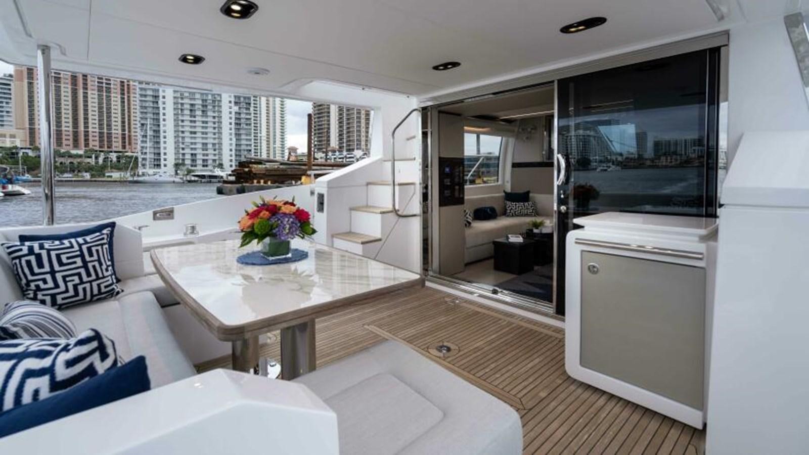 a large white living room with a large open floor plan aboard LIQUID ASSET Yacht for Sale
