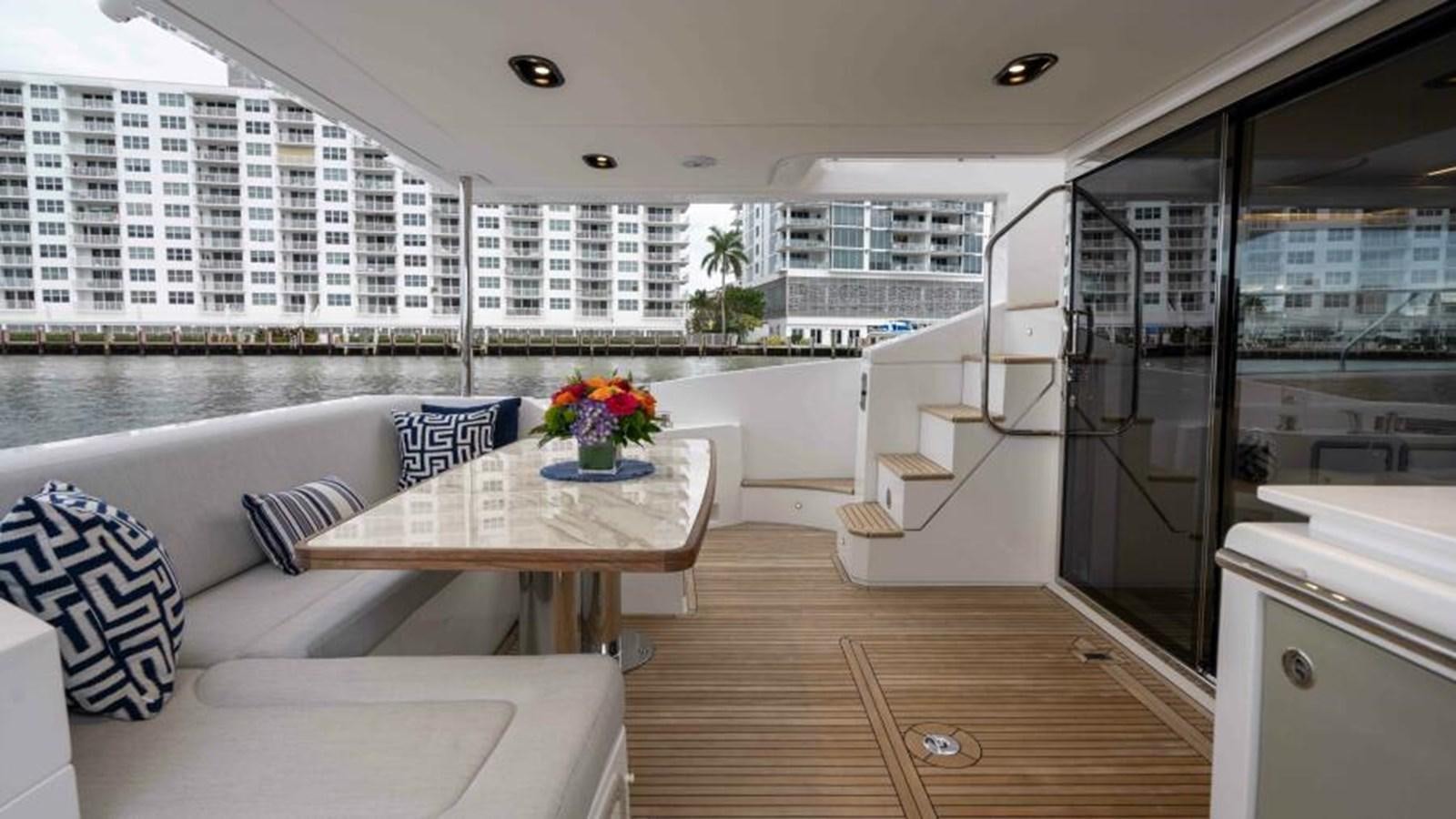 a room with a table and chairs aboard LIQUID ASSET Yacht for Sale