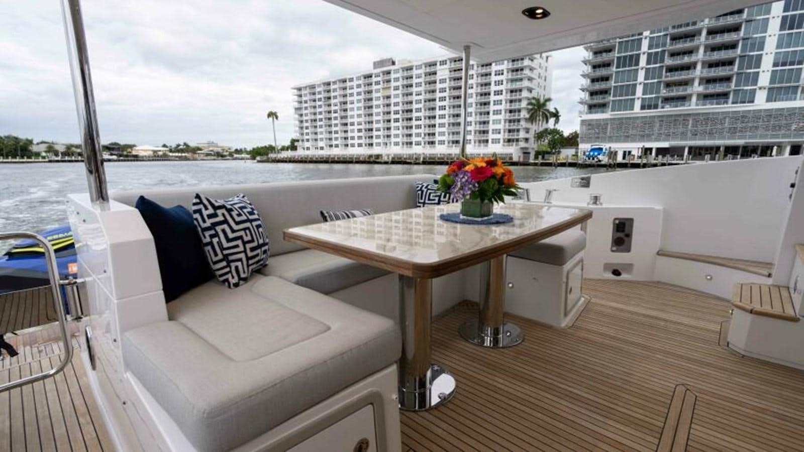 a room with a table and chairs aboard LIQUID ASSET Yacht for Sale