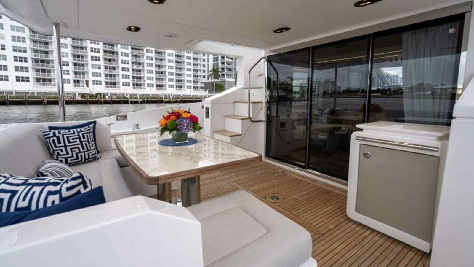 a room with a table and a couch aboard LIQUID ASSET Yacht for Sale