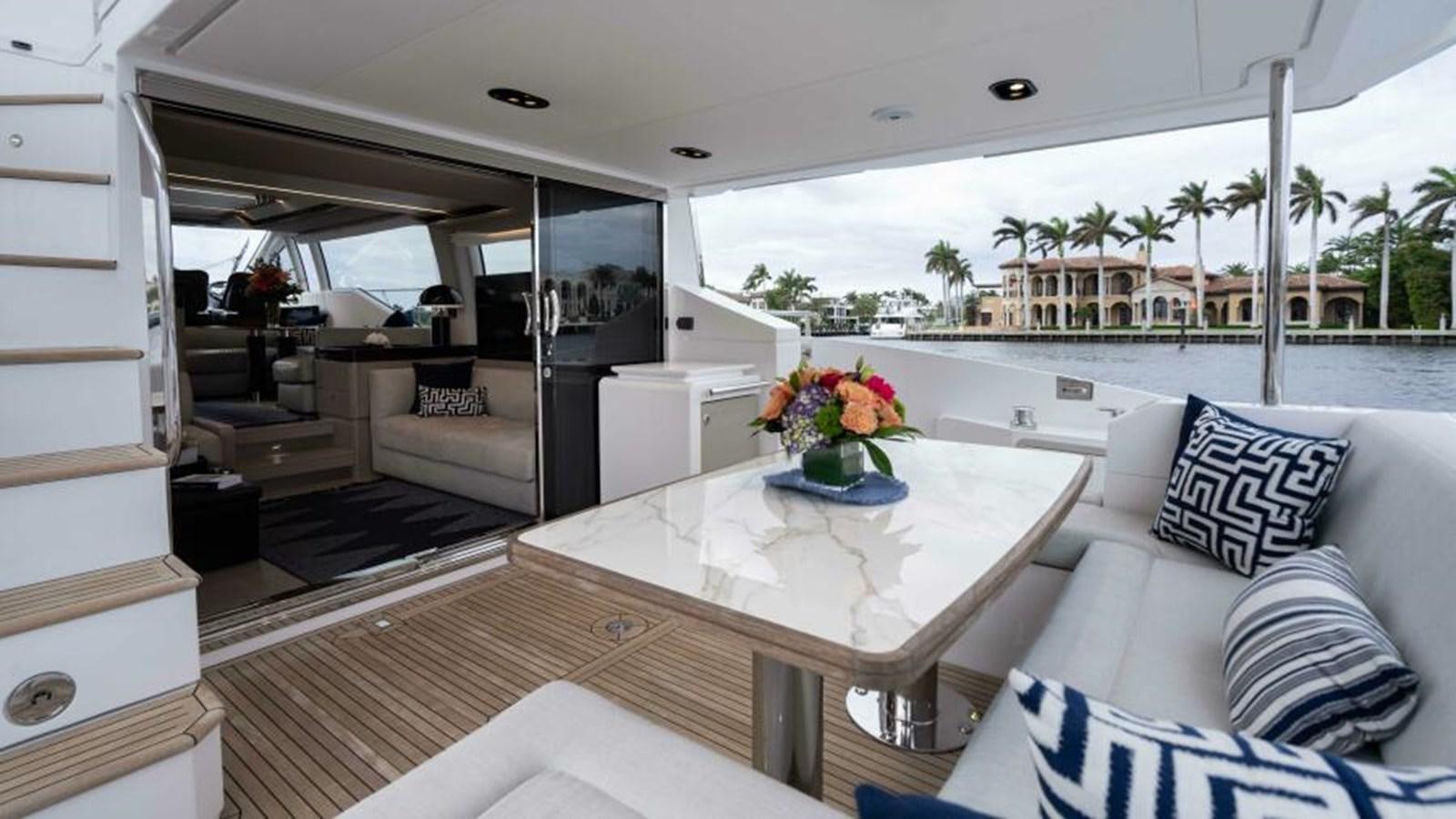 a room with a table and couches aboard LIQUID ASSET Yacht for Sale