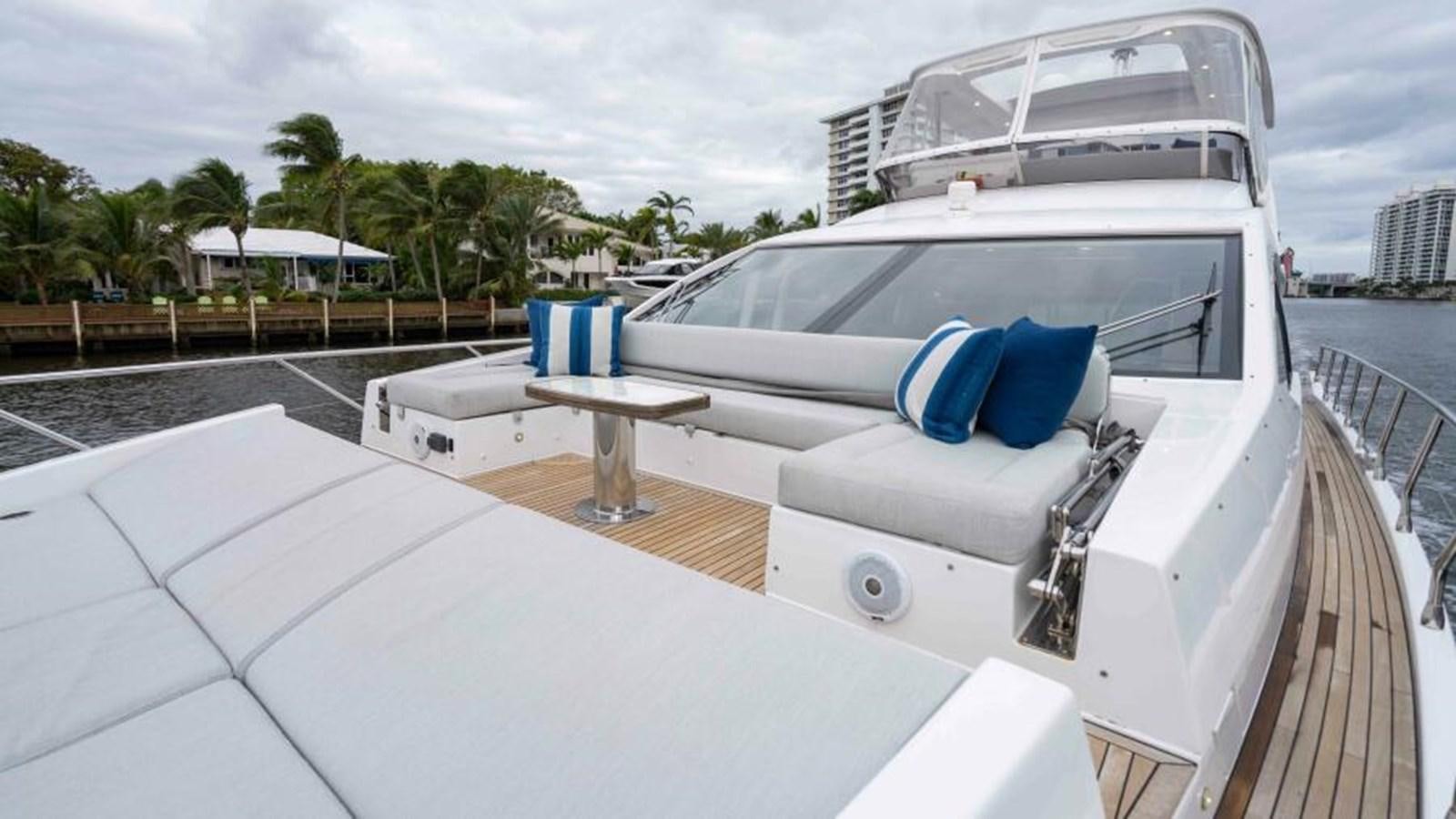 a white yacht with blue pillows aboard LIQUID ASSET Yacht for Sale